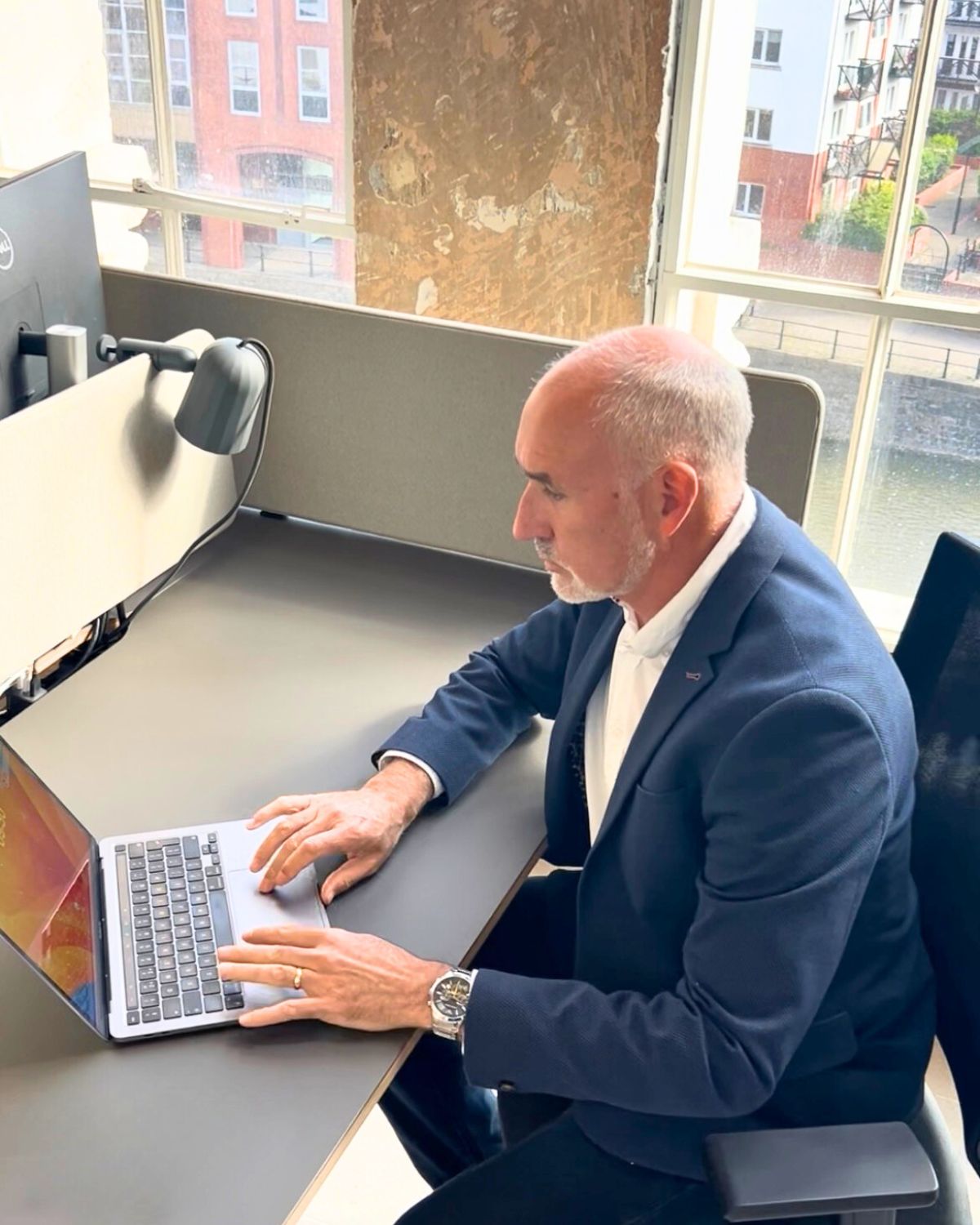 Simon sat at laptop